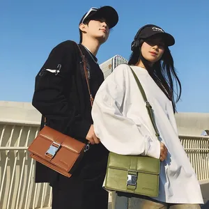 Stylish unisex crossbody flap bag in brown and green with silver buckle and shoulder strap