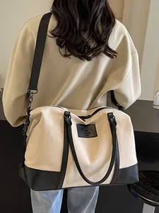 Large beige canvas and black leather travel bag shown on a model for travel or fitness