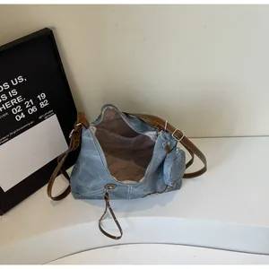 Detail view of large tote bag interior with patterned lining and blue faux leather exterior