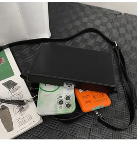 Internal view of black hard shell box bag showing capacity for phone and power bank