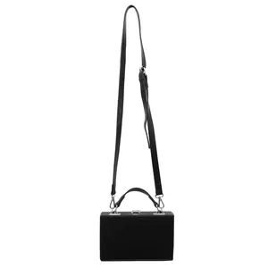 Minimalist black hard shell box bag with silver hardware and adjustable shoulder strap