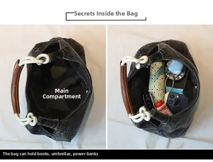 Spacious main compartment of black denim hobo bag showing large storage capacity