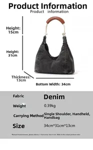 Detailed sizing chart for dark grey denim crescent bag with white rope handles