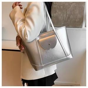 Silver tote bag showing shoulder carry style and metallic faux leather texture