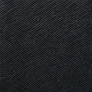 Macro shot of durable dark blue denim fabric texture and detailed twill weave pattern