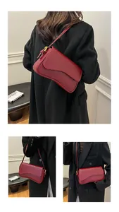 Détails d'un sac bandoulière en cuir gaufré bordeaux avec boucle en métal doré élégante