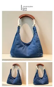 Close-up of denim hobo bag featuring thick cotton rope handle and brown leather grip