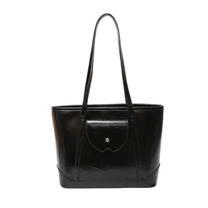 Minimalist black tote bag with silver buckle flap pocket and dual shoulder straps