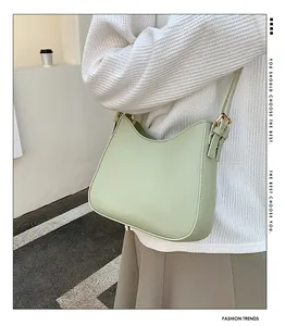 Minimalist light green hobo bag in smooth PU leather with adjustable gold hardware
