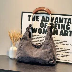 Washed grey denim shoulder bag with thick hemp rope handle and leather grip