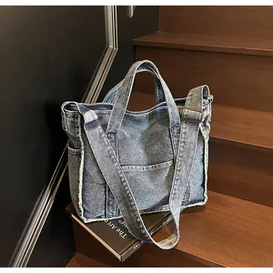 Macro detail of casual denim tote bag with frayed edges on rustic wooden stairs