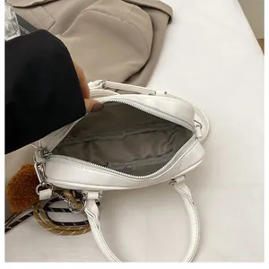 Detailed top view of white Boston bag interior showing spacious grey lining and metal zippers