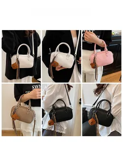 Litchi texture Boston bag detail showing multiple carry styles and cute bear charm