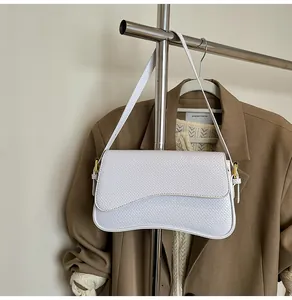 Détail du sac bandoulière blanc à texture croco avec boucle de réglage dorée élégante