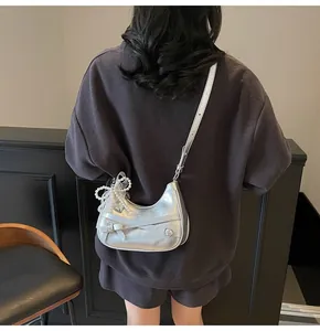 Silver crescent moon shoulder bag with lace bow and pearl charm shown on model