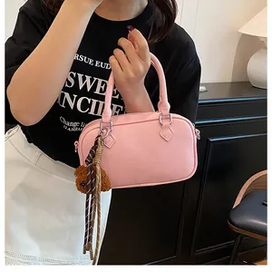 Detailed macro view of pink lychee pattern leather mini Boston bag with bear charm