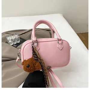 Pink litchi texture boston bag with cute teddy bear charm and woven rope detail