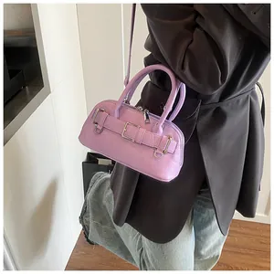Detail of lavender mini Boston shell bag with decorative metal buckle and textured leather