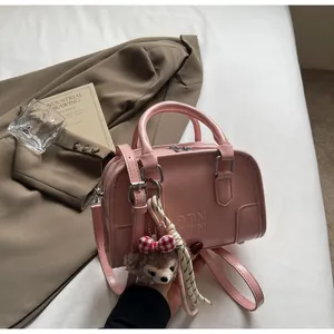 Pink matte leather Boston bag with embossed ATN letters and cute plush bear charm