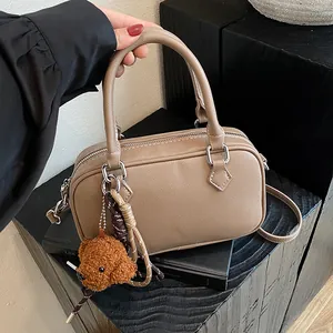 Khaki Boston bag in lychee pattern leather with teddy bear charm and shoulder strap