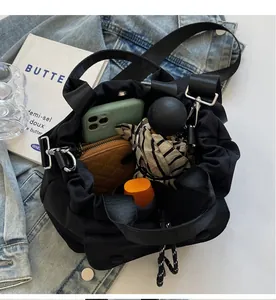 Interior view of black drawstring bucket bag showing spacious storage for wallet and umbrella
