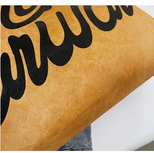 Detailed macro shot of yellow waterproof Tyvek material with stylish black printed text