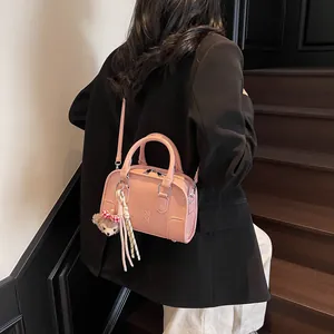 Pink embossed lettering Boston handbag with plush bear charm and striped ribbon handle