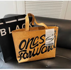 Detail of waterproof ginger yellow tote bag with black oncs Forward printed lettering
