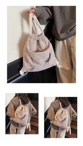 Detail of light beige waffle knit drawstring backpack with hoodie style front pocket