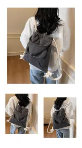 Detail of dark grey waffle knit backpack with hoodie style rabbit ears and cotton ropes