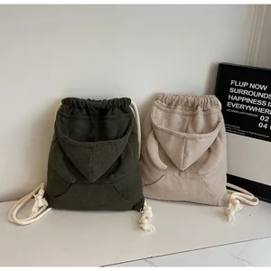 Detail of waffle knit texture and creative hoodie design on casual drawstring backpacks