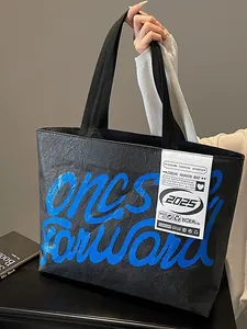 Waterproof black Tyvek tote bag with blue Forward script print and wide shoulder straps