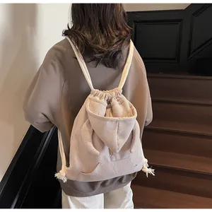 Detailed back view of beige waffle knit drawstring backpack with hoodie style pocket