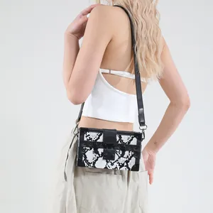 Chic black and white snake skin print trunk bag with metallic corners and cross-body strap