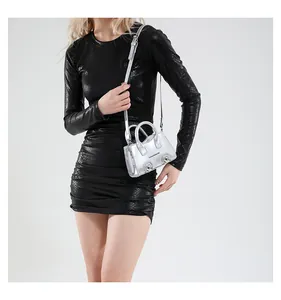Detail of silver mini motorcycle shell bag with rivets and Fashion & Bags text