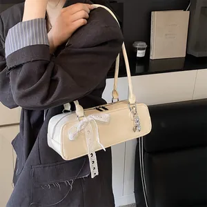 Sac baguette en cuir verni blanc crème avec nœud en dentelle et pendentif cœur argent