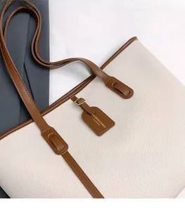 Top view of large tote bag in beige pebbled leather with brown contrast shoulder straps