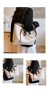 Close-up of cream textured leather tote bag with brown straps and fashion tag