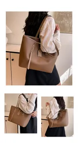 Detail of caramel brown tote bag with litchi texture, long strap and metal zip closure