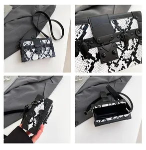 Macro view of luxury box bag with snake pattern texture and matte black metal hardware