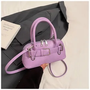 Detailed close-up of lavender shell bag with silver buckle and smooth PU leather texture