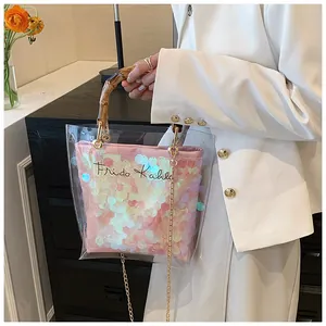 Detail of transparent PVC bag with bamboo handle and pink sequin insert featuring Frida Kahlo