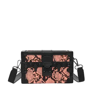 Pink snake-pattern box crossbody bag with black leather trim and metal rivets