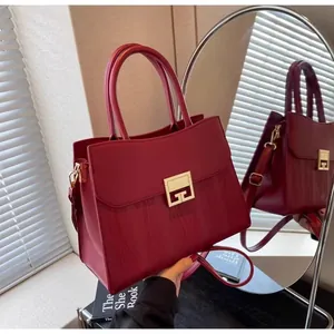 Detail of red leather bridal handbag with gold metal clasp and 4G brand logo design