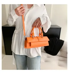 Schicke orangefarbene Baguette-Tasche mit Doppelgriffen und abnehmbarem Schultergurt