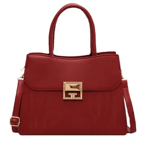 Elegant dark red leather handbag with gold metal clasp and adjustable shoulder strap
