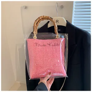 Close-up of pink inner pouch with Frida Kahlo signature and bamboo handle