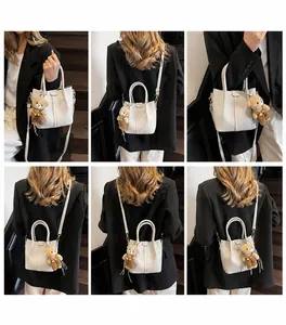 Multi-angle view of white faux leather bucket bag with cute plush bear pendant accessory