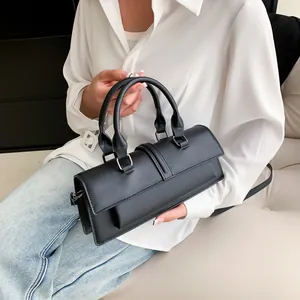French style black leather baguette bag with dual handles and detachable shoulder strap