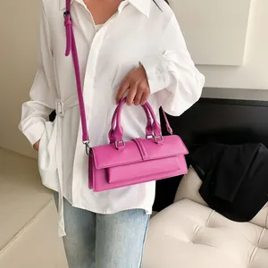 Elegant bright pink rectangular baguette bag with top handles and adjustable strap